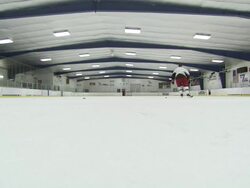 Wide Shot static - A hockey player practices in a rink. / North Carolina, USA Stock Footage