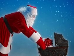 Santa Claus puts a gift in Baby Carriage Stock Footage