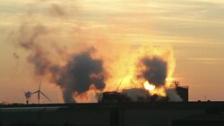 Sunset over the Iggesund paper board manufacturer in Workington, Cumbria, UK, at sunset, with wind turbines. The plant is powered by a biofuel power station, on site. Stock Footage