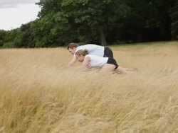 Male and female exercising in park Stock Footage