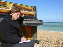 young woman writes on the coast Stock Footage