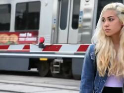 Teenage girl with train going by Stock Footage