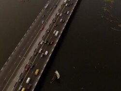 WS AERIAL DS View of vehicles moving on freeway with tailback and black water / Lagos, Nigeria Stock Footage