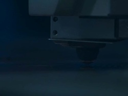 Close up on laser cutter as it punches holes in a sheet of metal. Stock Footage