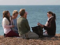 MS, Family with two children (10-11, 12-13) having picnic on Brighton beach, Brighton, Sussex, United Kingdom Stock Footage