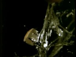 High Speed - Arrow through egg against black background Stock Footage