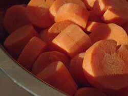 Carrots cut into in a bowl aluminum Stock Footage