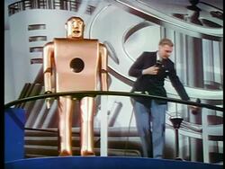 1940 man standing next to robot + giving it cigarette / New York World's Fair / industrial Stock Footage