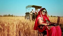 Female farmer working on laptop in the field Stock Footage