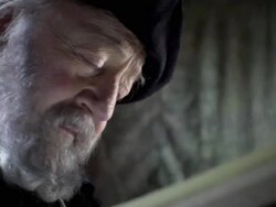 A man in period clothing reads a book and refers to a celestial map. Stock Footage