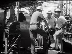 1947: USA OIL INDUSTRY: DRILLING: CU Seismograph drum, male worker SOT talking Geologist or Engineer saying will have to make another connection, scientist saying how deep now & something about 50 feet. Applied science, scientific, calculations. Instructional Video