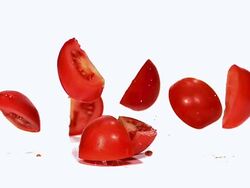 MS SLO MO Shot of falling red tomatoes(solanum lycopersicum) cutted fruits / Vieux Pont, Normandy, France Stock Footage