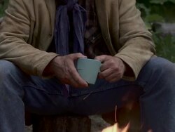 Cowboy sits by campfire Stock Footage