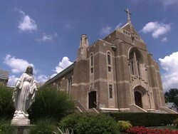 Suburban church with statue of the Virgin Mary Stock Footage