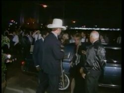 1986 MONTAGE WS CU MS Stars of soap opera Dallas arriving at gala including actress Morgan Fairchild, actor Larry Hagman and his wife Maj Axelsson, and actress Linda Gray / Dallas, Texas, USA Stock Footage