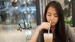 Woman drinking coffee in the cafe Stock Footage
