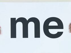 Young man holding sign that reads me Stock Footage