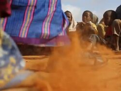 Refugees sitting down in line Stock Footage
