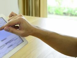 Dolly shot - Man checking stock graph on tablet Stock Footage