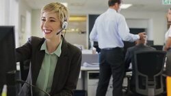Businesswoman wearing headset using computer Stock Footage