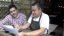 Waiter sharing ideas with business owner of a new menu Stock Footage