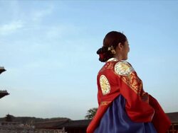 CU PAN Lady in queen Dress standing behind Gyeongbokgung Palace / Seoul, South Korea  Stock Footage