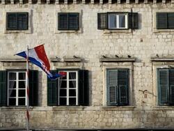 CROATIAN FLAG AND SHUTTERED WINDOWS Stock Footage