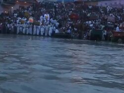 Pilgrims worshipping at riverbank, Ganges River, Haridwar, Uttarakhand, India Stock Footage