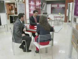 TS WS  kitchen salesman and young couple seated at desk discussing plans Stock Footage