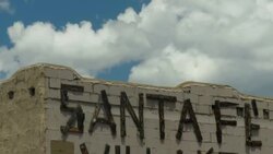 Time lapse of adobe Sa ta Fe building with sign and moving clouds Stock Footage