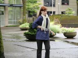 WS PAN Woman talking on phone while walking through urban park / Portland, Oregon, USA Stock Footage