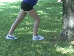 young woman doing stretching exercises outdoors Stock Footage