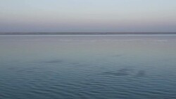 Sunset and twilight are reflected in the calm glassy flat River Jamuna in Northern Bangladesh Stock Footage