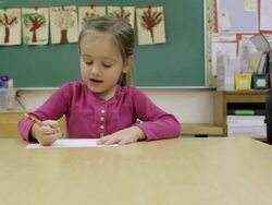 MS Young girl working on writing inside classroom at school / Minneapolis, Minnesota, United States Stock Footage