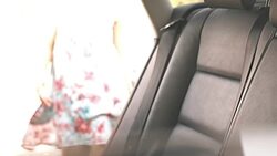 Mother fastening seat belt for children in car Stock Footage