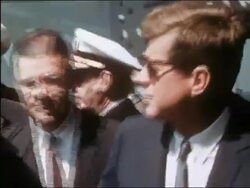 1962 US president Kennedy and Robert McNamara walking toward CAM on deck of Navy ship Stock Footage