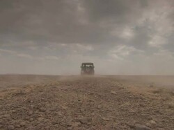 Wide Shot static - An SUV drives across a vast, flat desert / Sahara, Egypt Stock Footage