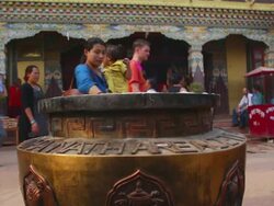 WS Shot of Woman stops with child at incense pot at Boudhanath Stupa and blesses herself and her child / Kathmandu, Nepal Stock Footage