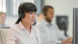 TU Female helpline operator answering a call Stock Footage