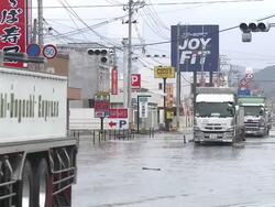 Destruction caused by tsunami after magnitude 9 Tohoku earthquake, north east Japan, March 2011. Trucks drive through tidal flooding in Ishinomaki, Miyagi Prefecture after tsunami Stock Footage