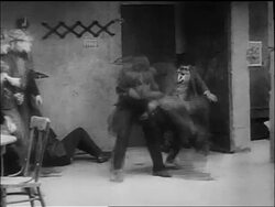 B/W 1917 policeman Charlie Chaplin singlehandedly fighting group of men in bar Stock Footage