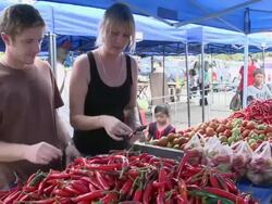 MS Shot of Couple sampling chillis in market / Kota Kinabalu, Sabah, Malaysia  Stock Footage