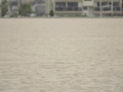 A young woman doing speed and agility training with parachutes on the beach.  - Super Slow Motion - filmed at 240 fps Stock Footage