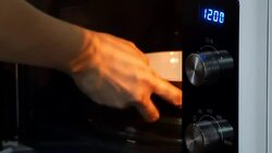 Cooking using a microwave Stock Footage