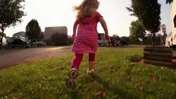 Close up of little girl's feet as she runs through a campground Stock Footage