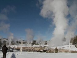 MS Man walking on snow front of geyser field / Yellowstone National Park, Wyoming, United States  Stock Footage