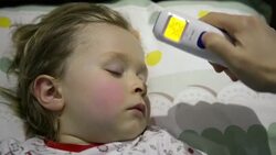 Mother taking the son's temperature Stock Footage