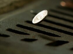 Money Down the Drain - High speed English coin, 5p falling on and in to road drain, low angle 6 BCU Stock Footage