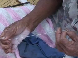 Senior woman spinning thread, village of Mapajo inhabited by the tribe of Mosetenes, Bolivia, Amazon Stock Footage