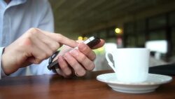 Man Using Smartphone in a Cafe. Stock Footage